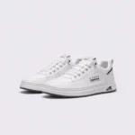 men's perforated slip-on sneakers - breathable knit casual walking shoes with cushioned sole in white, front 45-degree view of the pair on a light gray background