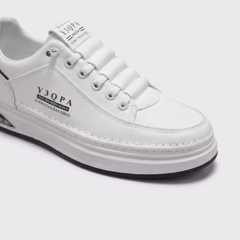 men's perforated slip-on sneakers - breathable knit casual walking shoes with cushioned sole in white, close-up view of the toe on a light gray background