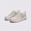 smooth-grain lace-up court sneakers - low-top casual shoes with a flat one-piece sole in beige, front 45-degree view of the pair on a light gray background