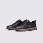 smooth-grain lace-up court sneakers - low-top casual shoes with a flat one-piece sole in black, front 45-degree view of the pair on a light gray background