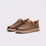 smooth-grain lace-up court sneakers - low-top casual shoes with a flat one-piece sole in khaki, front 45-degree view of the pair on a light gray background