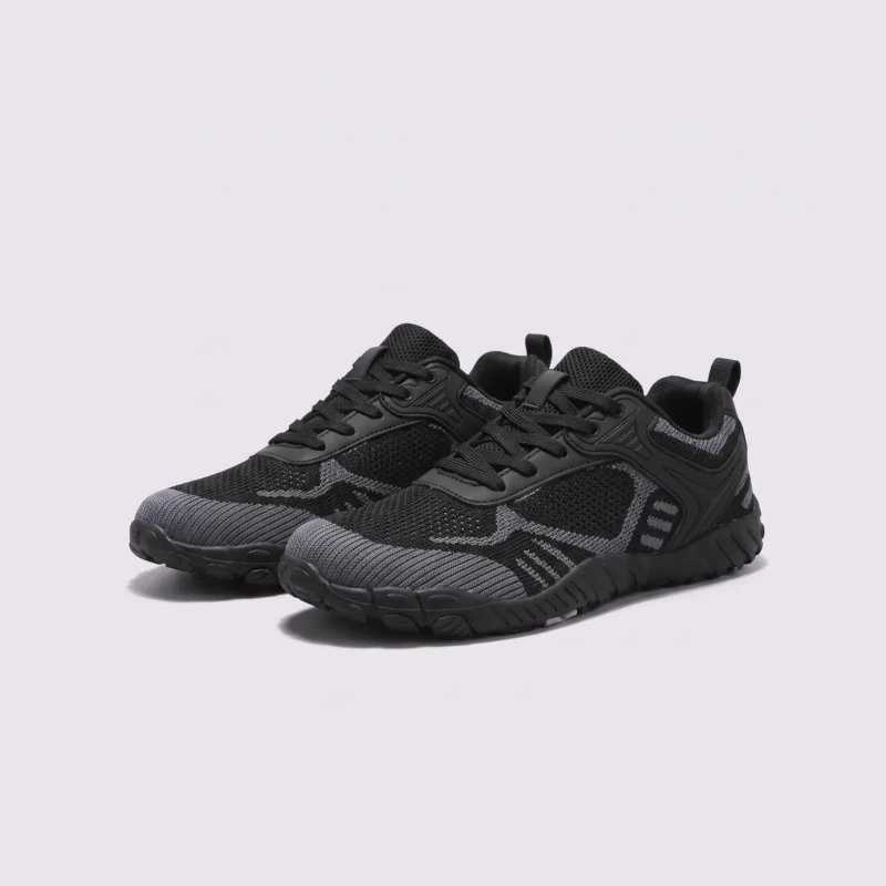 wide-toe knit trail sneakers - flexible thickened rubber outsole with a cushioned insole in black, front 45-degree view of the pair on a light gray background