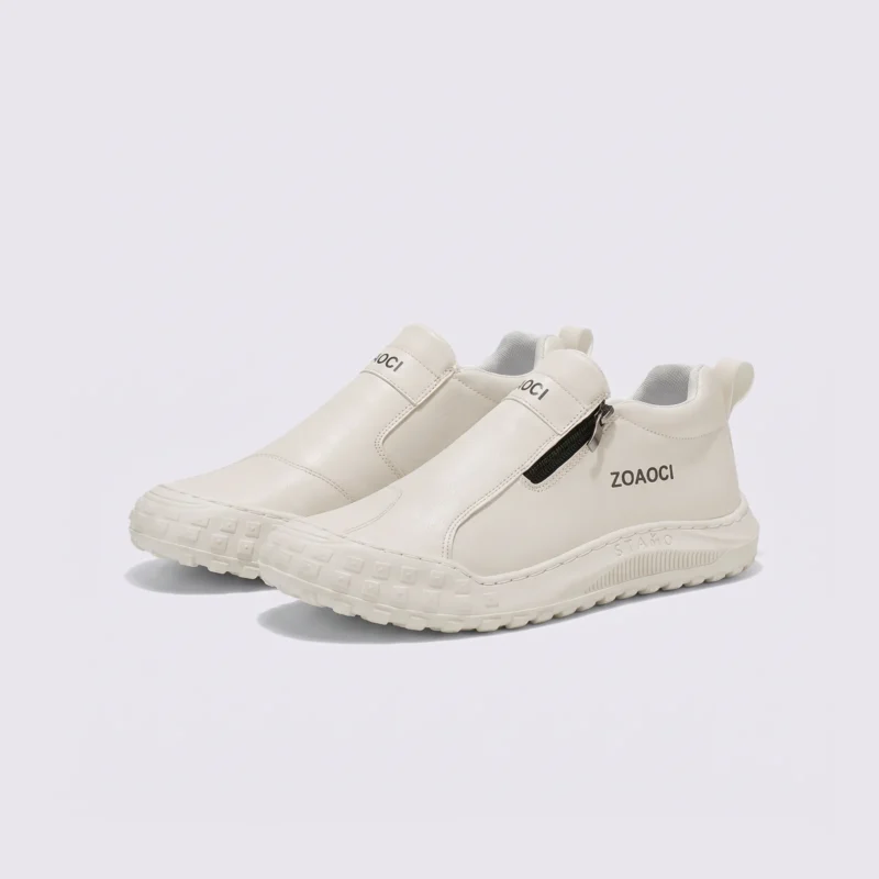 zip slip-on casual sneakers - lace-free smooth-upper shoes with a lugged thick sole in cream, front 45-degree view of the pair on a light gray background