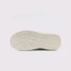 zip slip-on casual sneakers - lace-free smooth-upper shoes with a lugged thick sole in cream, outsole tread view on a light gray background