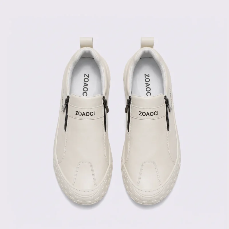 zip slip-on casual sneakers - lace-free smooth-upper shoes with a lugged thick sole in cream, top-down view of the pair on a light gray background