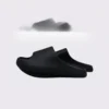 negative heel arch support slide sandals - thick platform one-piece eva slides for women in black, left side profile view on a light gray background