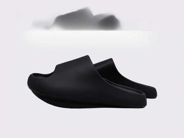 negative heel arch support slide sandals - thick platform one-piece eva slides for women in black, left side profile view on a light gray background