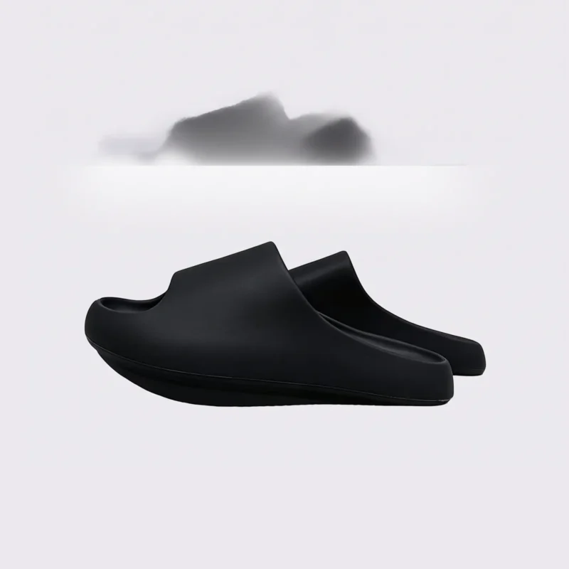 negative heel arch support slide sandals - thick platform one-piece eva slides for women in black, left side profile view on a light gray background