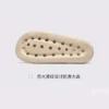 negative heel arch support slide sandals - thick platform one-piece eva slides for women in black, outsole tread view on a light gray background