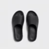 negative heel arch support slide sandals - thick platform one-piece eva slides for women in black, top-down view of the pair on a light gray background