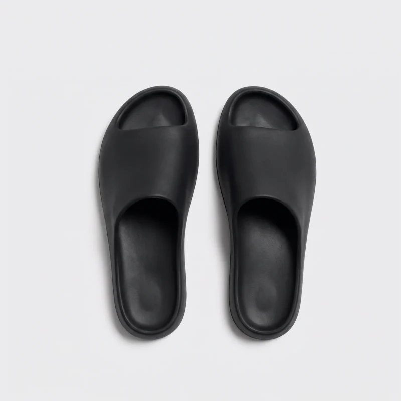 negative heel arch support slide sandals - thick platform one-piece eva slides for women in black, top-down view of the pair on a light gray background