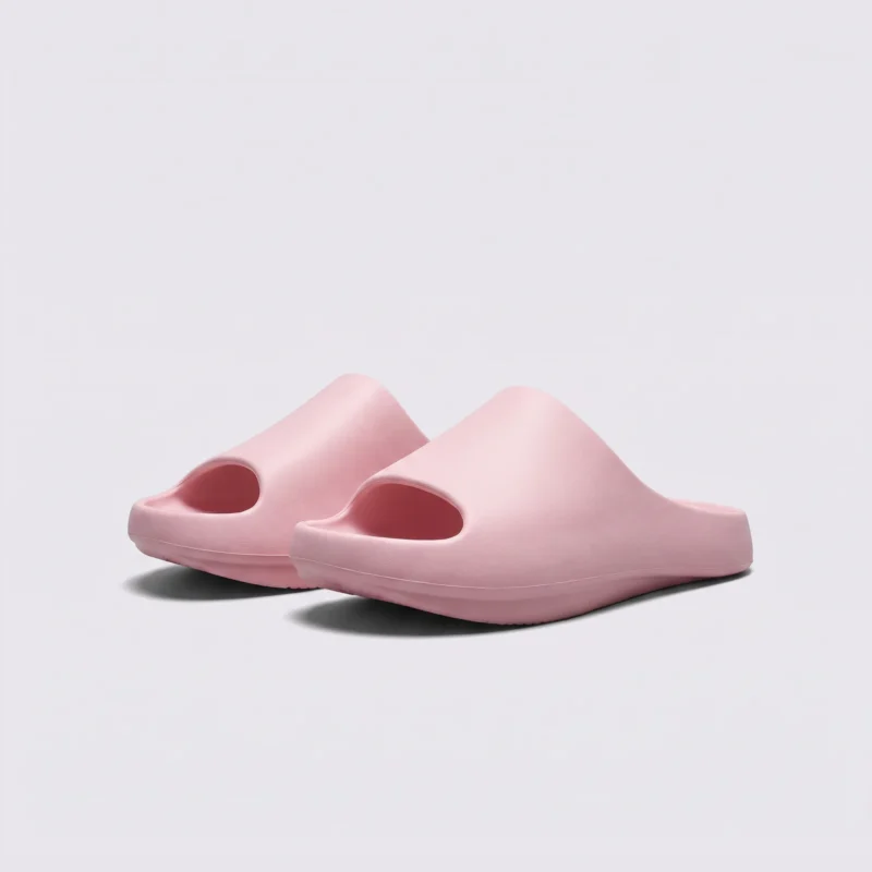 negative heel arch support slide sandals - thick platform one-piece eva slides for women in pink, front 45-degree view of the pair on a light gray background
