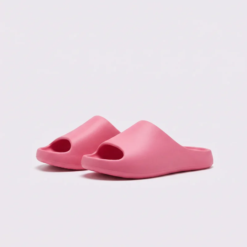 negative heel arch support slide sandals - thick platform one-piece eva slides for women, front 45-degree view of the pair on a light gray background
