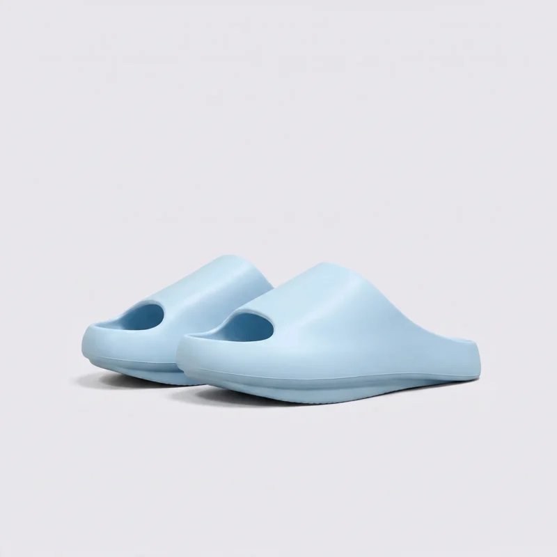 negative heel arch support slide sandals - thick platform one-piece eva slides for women, front 45-degree view of the pair on a light gray background