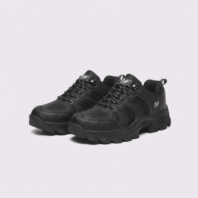 Pair of black AZEKA outdoor trail hiking shoes, front 45 degree view, thick black lug outsole on light gray background