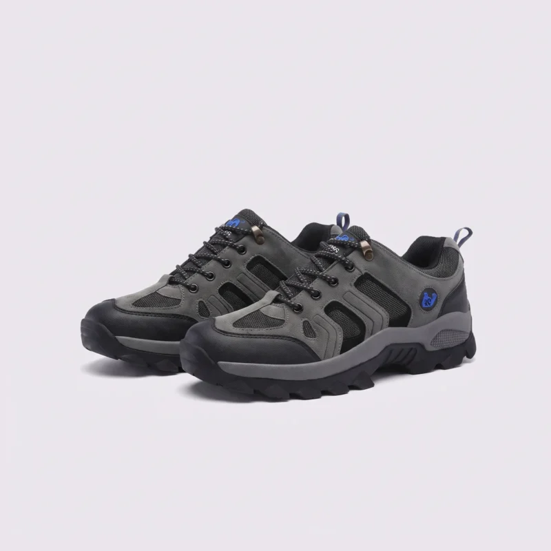 Pair of gray AZEKA outdoor trail hiking shoes, front 45 degree view, thick black lug outsole on light gray background