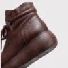 retro platform ankle boots chunky sole side zip warm fleece lined casual short boots in black, close-up view of the heel on a light gray background