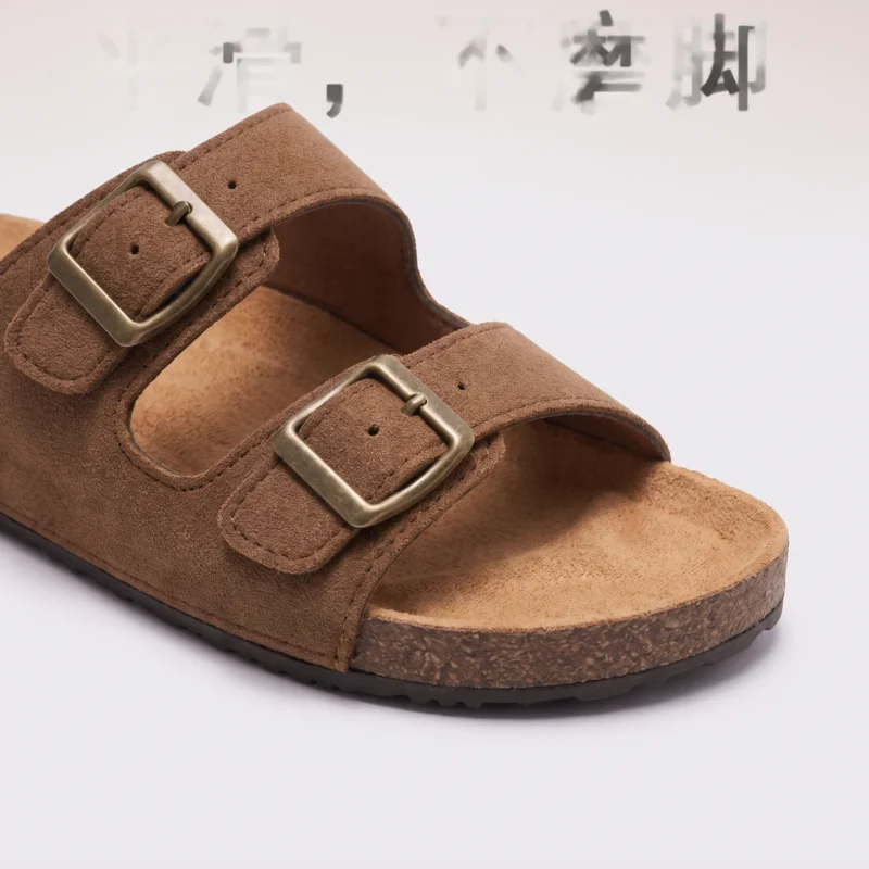 two-strap buckle casual sandals - adjustable double-strap slides with cushioned cork footbed for men and women in brown, close-up view of the toe on a light gray background