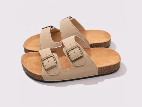 two-strap buckle casual sandals - adjustable double-strap slides with cushioned cork footbed for men and women in cream, front 45-degree view of the pair on a light gray background