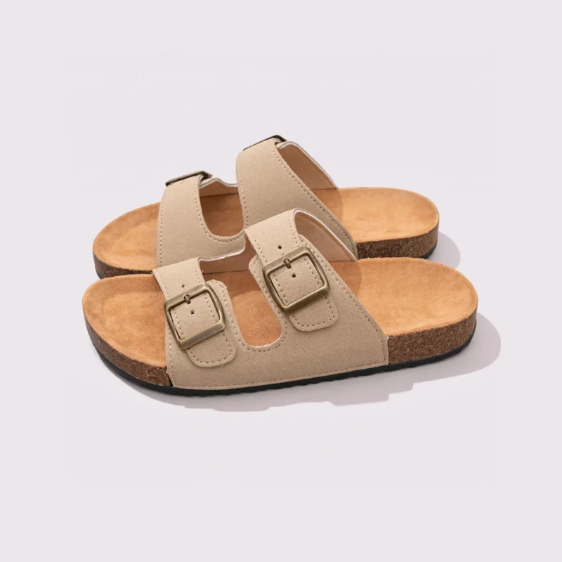 two-strap buckle casual sandals - adjustable double-strap slides with cushioned cork footbed for men and women in cream, front 45-degree view of the pair on a light gray background