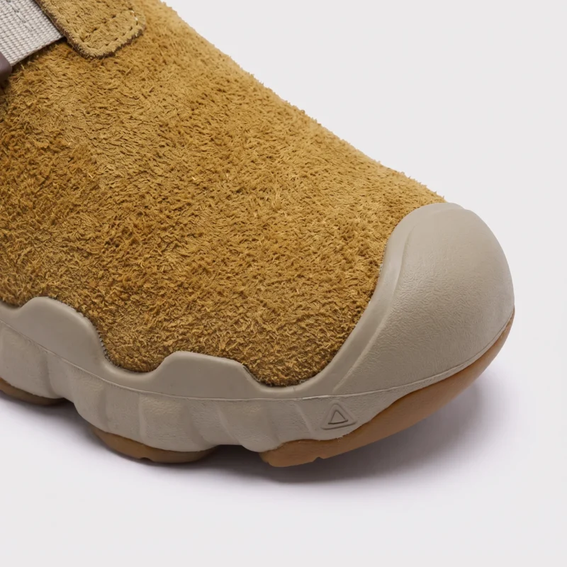 unisex wave-sole closed-toe clog slippers - suede slip-on mules with adjustable webbing strap and thick cushioned sole, close-up view of the toe on a light gray background