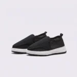 wide fit soft canvas slip-on shoes breathable mesh roomy toe everyday comfort in black, front 45-degree view of the pair on a light gray background