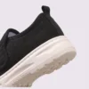 wide fit soft canvas slip-on shoes breathable mesh roomy toe everyday comfort in black, close-up view of the heel on a light gray background