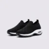 slip-on quilted sock sneakers - lace-free everyday shoes with a cushioned thick sole and heel window in black, front 45-degree view of the pair on a light gray background