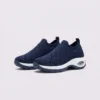 slip-on quilted sock sneakers - lace-free everyday shoes with a cushioned thick sole and heel window in blue, front 45-degree view of the pair on a light gray background