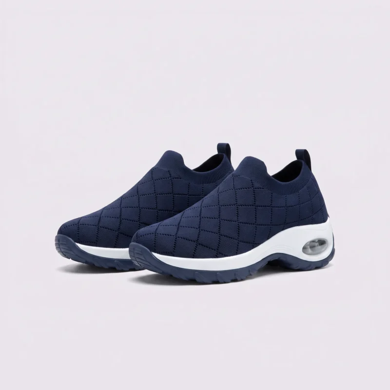 slip-on quilted sock sneakers - lace-free everyday shoes with a cushioned thick sole and heel window in blue, front 45-degree view of the pair on a light gray background