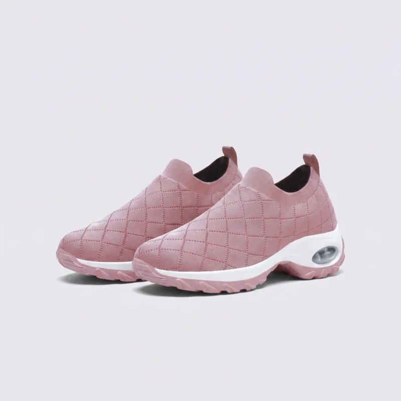 slip-on quilted sock sneakers - lace-free everyday shoes with a cushioned thick sole and heel window in pink, front 45-degree view of the pair on a light gray background