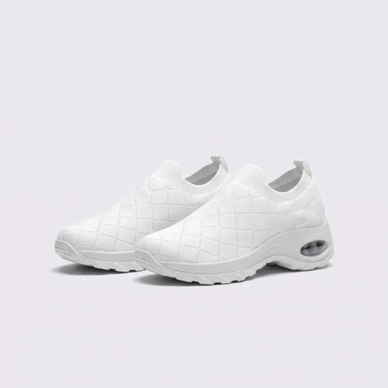 slip-on quilted sock sneakers - lace-free everyday shoes with a cushioned thick sole and heel window in white, front 45-degree view of the pair on a light gray background