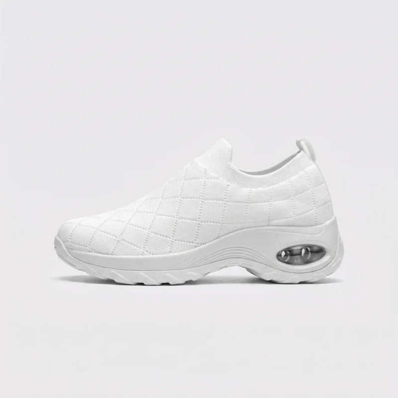 slip-on quilted sock sneakers - lace-free everyday shoes with a cushioned thick sole and heel window in white, left side profile view on a light gray background