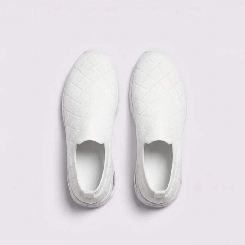 slip-on quilted sock sneakers - lace-free everyday shoes with a cushioned thick sole and heel window in white, top-down view of the pair on a light gray background