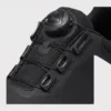 boa closure hiking sneakers in black, close-up view of the boa dial on a light gray background