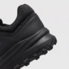 boa closure hiking sneakers in black, close-up view of the heel on a light gray background