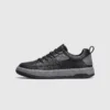 chunky sole leather casual sneakers in black, left side profile view on a light gray background
