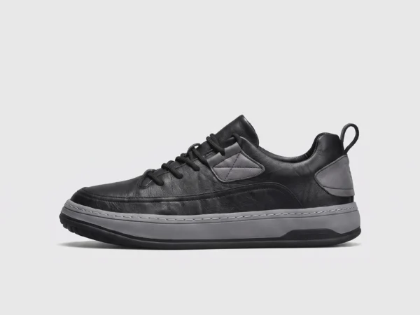 chunky sole leather casual sneakers in black, left side profile view on a light gray background