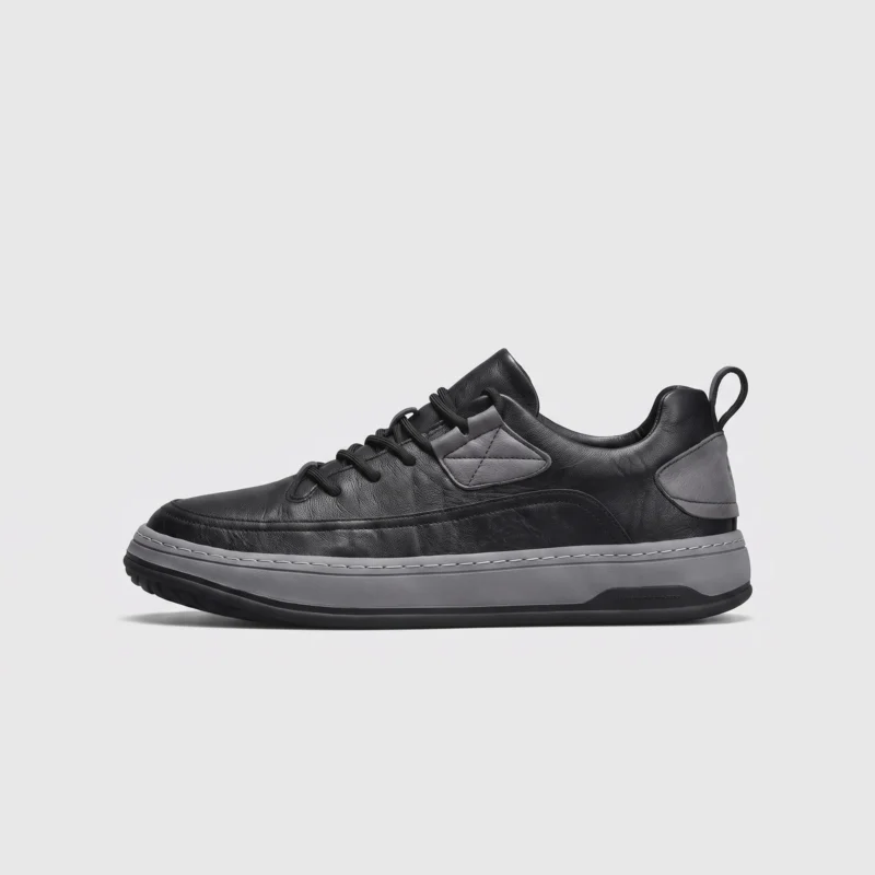chunky sole leather casual sneakers in black, left side profile view on a light gray background