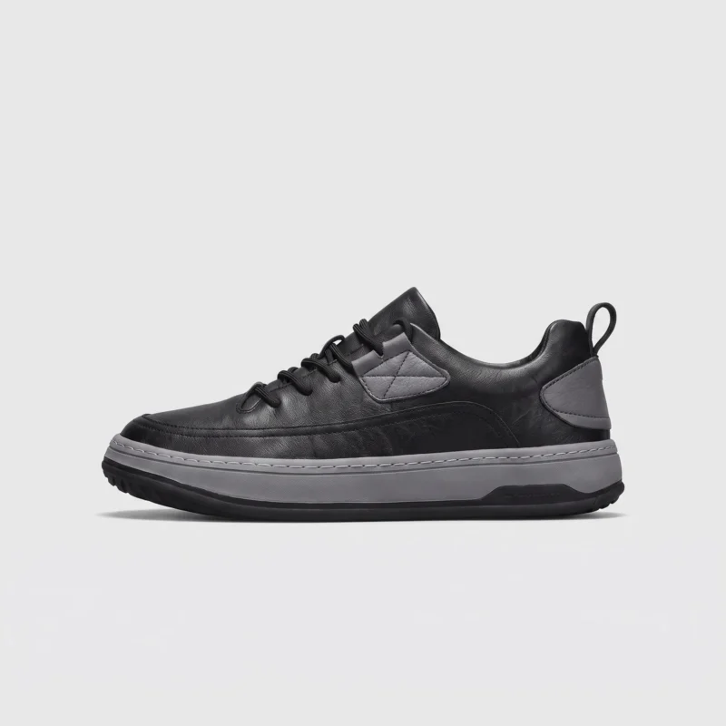 chunky sole leather casual sneakers in black, right side profile view on a light gray background