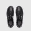 chunky sole leather casual sneakers in black, top-down view of the pair on a light gray background