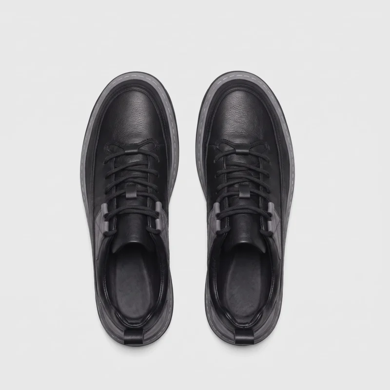 chunky sole leather casual sneakers in black, top-down view of the pair on a light gray background