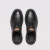 chunky sole leather ankle boots in black, top-down view of the pair on a light gray background