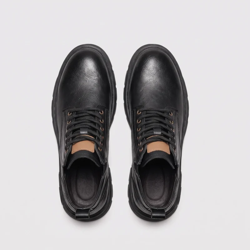 chunky sole leather ankle boots in black, top-down view of the pair on a light gray background