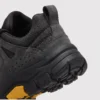 leather outdoor hiking sneakers in black, close-up view of the heel on a light gray background