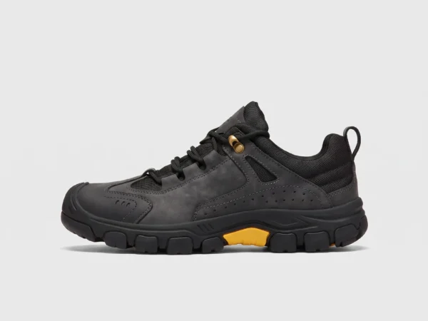 leather outdoor hiking sneakers in black, left side profile view on a light gray background