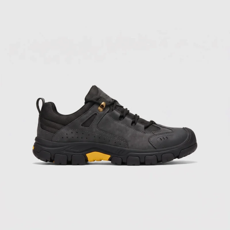 leather outdoor hiking sneakers in black, right side profile view on a light gray background
