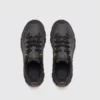 leather outdoor hiking sneakers in black, top-down view of the pair on a light gray background