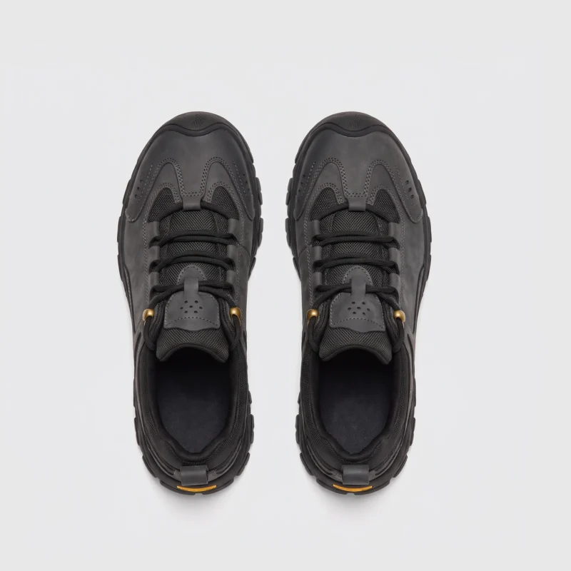 leather outdoor hiking sneakers in black, top-down view of the pair on a light gray background