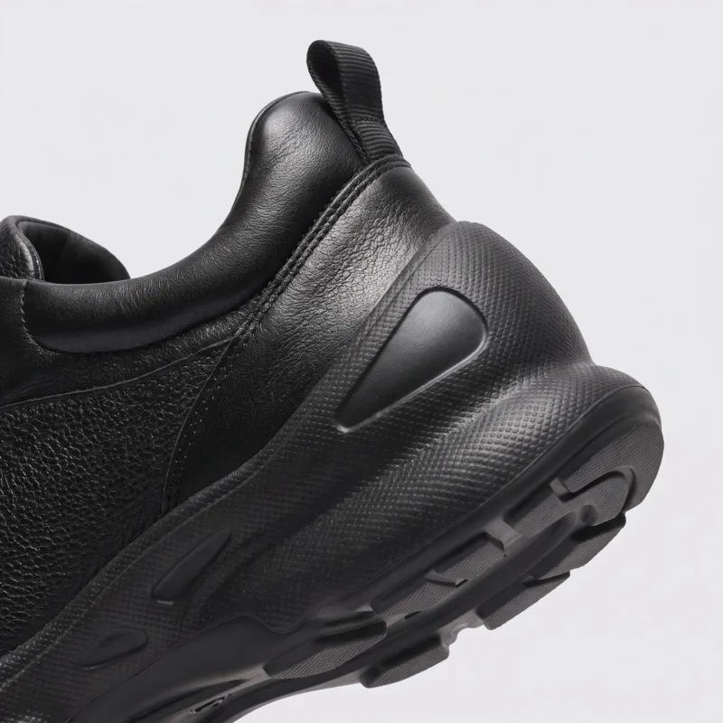 lightweight boa walking sneakers in black, close-up view of the heel on a light gray background